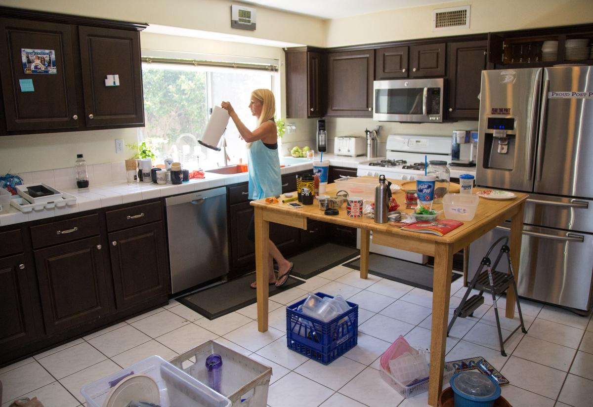 Professional organizer Kirsten Ranger of Organized & Orderly adjusts a counter top as she begins to finish up decluttering a kitchen at a private residence in Trabuco Canyon on Tuesday. ////ADDITIONAL INFORMATION: lansner.declutter - 7/7/15 - JOSH BARBER, - ORANGE COUNTY REGISTER - at on Tuesday, July 7, 2015 in Trabuco Canyon, Calif. Columnist Jon Lansner will have a room in his home "decluttered" by decluttering expert Kirsten Ranger of Organized & Orderly of Organized & Orderly
