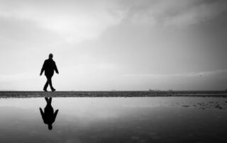 Minimalist walking on the beach black and white